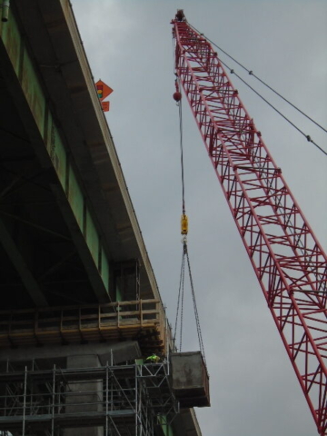 Close-up of the 110 ton crane lifting the bin for dismantled scaffolding