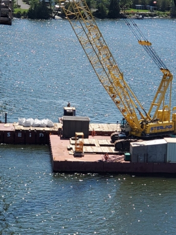Removing meter bags of debris on the barge to the project site