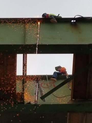 Torch cutting the girder for removal