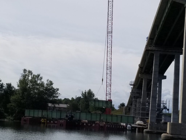 Removed section of girder, cut and being removed from the barge