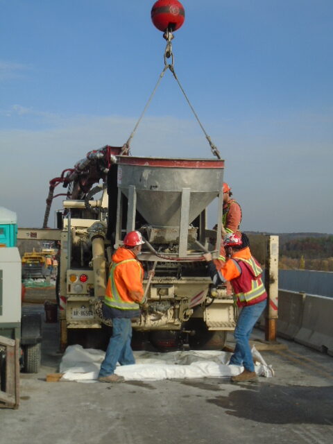 Offloading concrete from the hopper into the pump truck