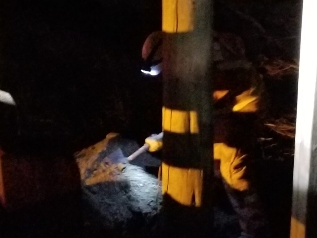 Filling in the hole around the newly placed pole