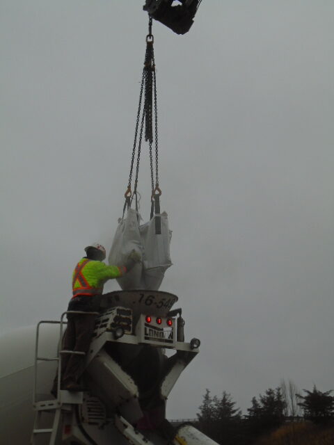 Close-up of concrete mix being released into the truck