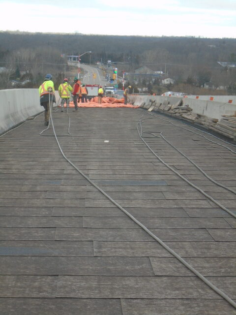 Placing the glycol lines to be used to heat the deck prior to asphalt placement