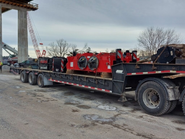 Hydraulic crane sections being delivered to site