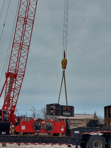 110 ton crane removing the new crane sections from the truck