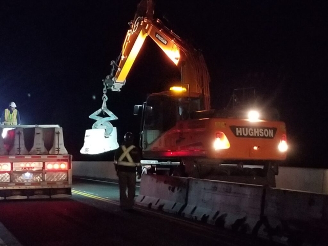 Excavator with clamp attachment offloading the TCB