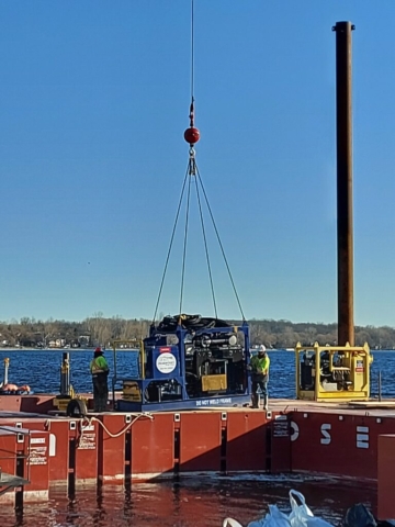 Lowering the power pack into place on the barge