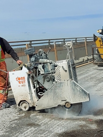 Cutting access in the concrete deck for scaffolding installation