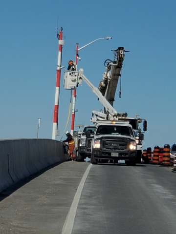 Preparing to relocate the temporary traffic signal poles