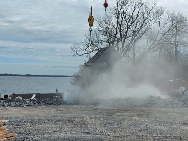 The crane emptying the concrete rubble to be sorted