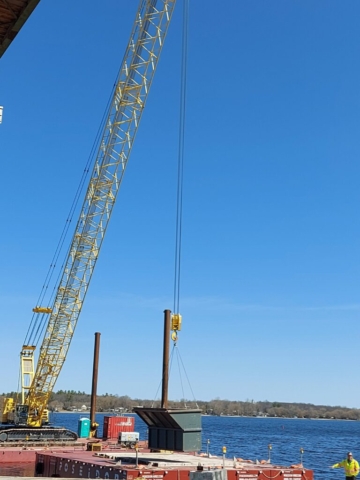 Lowering the containment bin to the barge to be emptied and sorted