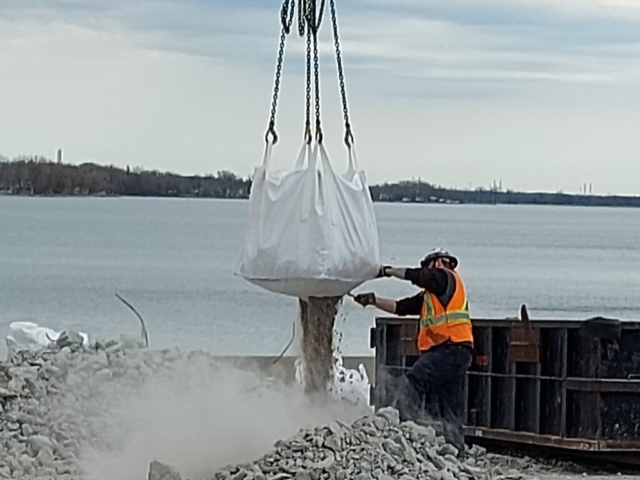 Emptying a bag of debris from the deck removal