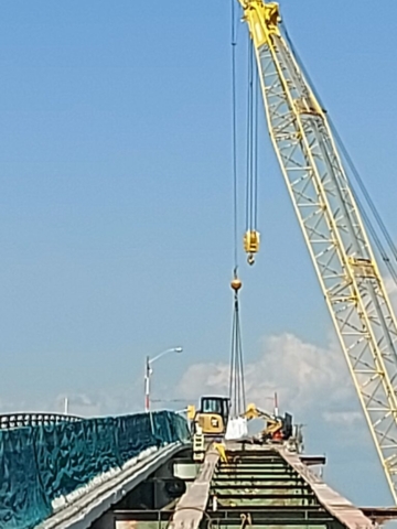 200 ton crane removing debris bag from the false decking to the barge