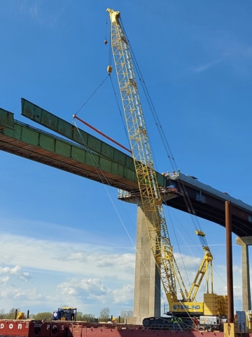 Starting to lower the first section of girder