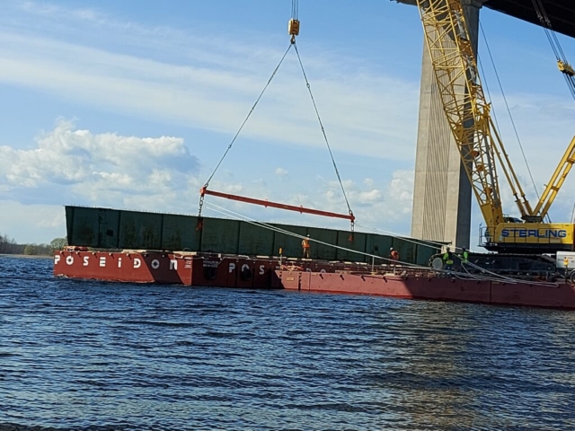 Girder section being lowered onto the barge