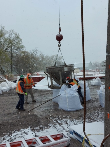 Using the hopper to fill the meter bags with granular