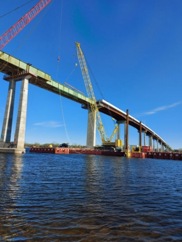 Placing the spreader bar on the second girder piece between piers 11 and 12 with the 200 ton crane