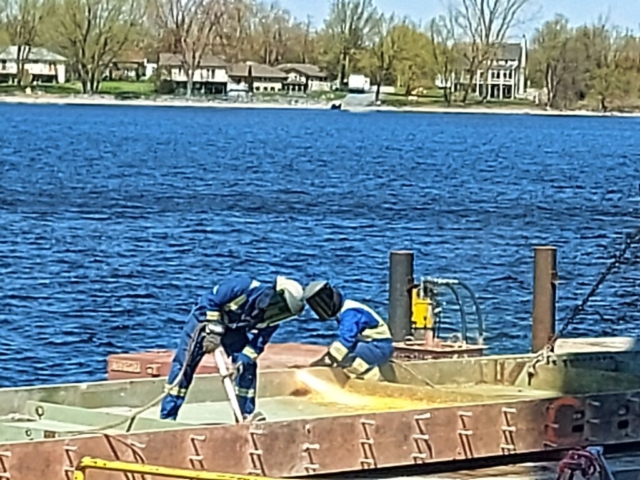 Torch cutting the girder for removal from site