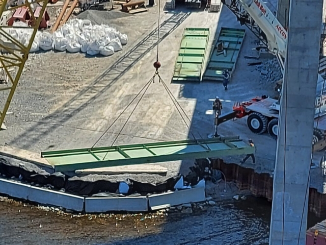 Top view of the crane moving the girder section from the barge