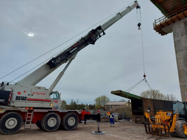 Loading the girder section onto the truck for removal from site