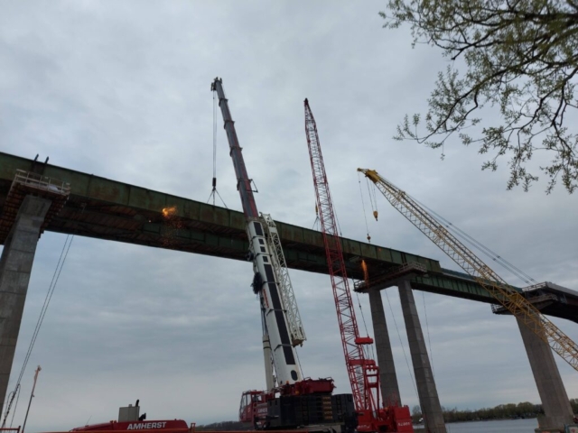 Torch cutting drop-in section of  girder, 160 and 300 ton cranes holding the girders, 200 ton crane removing false decking