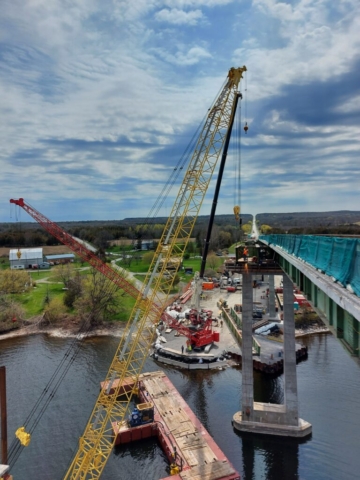 200 ton and 300 ton crane hooked up to pier 12 haunch girder section, torch cutting brackets for removal