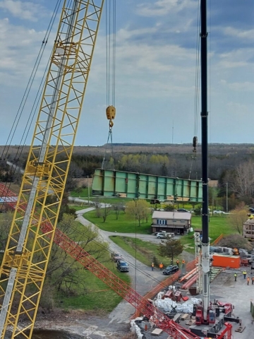 200 and 300 ton crane starting to lower the haunch section of girder on pier 12