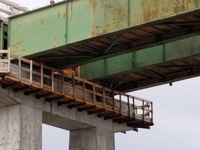 Cutting the approach girder at the top of pier cap 14