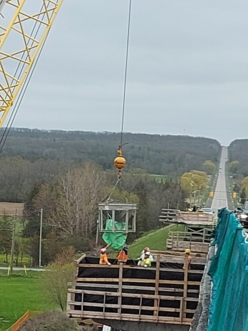 Lowering the concrete hopper to pier cap 12 for placement