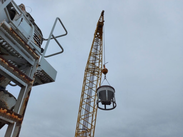 Hopper being lifted from the barge to the deck to the concrete truck