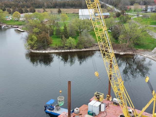 Lowering the hoppers to the boat after concrete placement