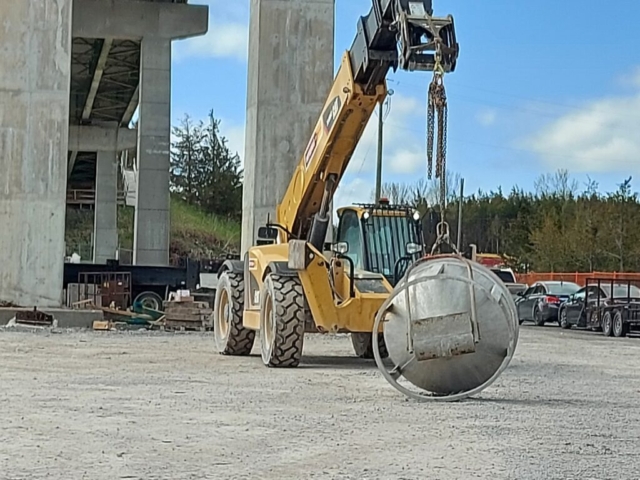 Telehandler moving the hopper for concrete placement