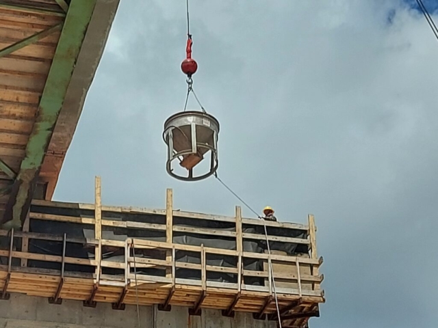 Concrete hopper being lowered to pier  cap 12