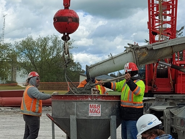 Concrete truck loading the hopper with concrete