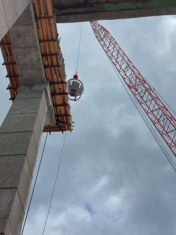 View from below of the hopper being lowered on to the pier cap