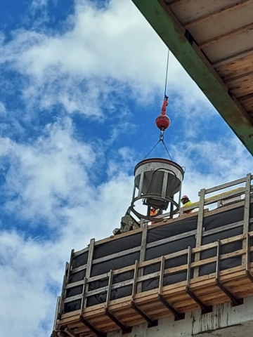 Hopper being lowered to pier cap 14 for concrete placement