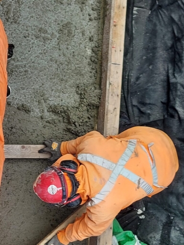 Smoothing / leveling the newly placed concrete on pier cap 14