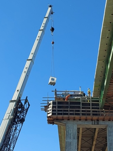 160 ton crane lowering the water container to be filled for concrete placement