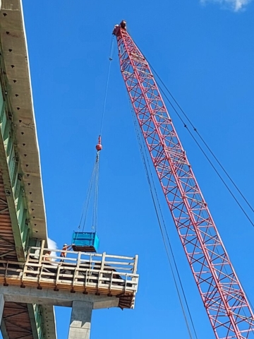 Materials being lowered to the pier by the 110 ton crane