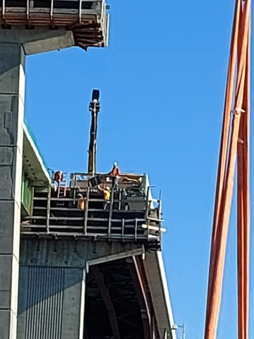 Lowering the bearing onto pier cap 11 for installation