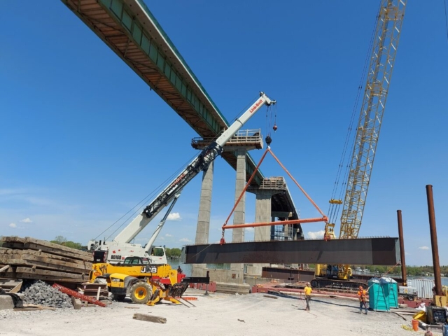 160 ton hydraulic crane moving  the first girder piece onto the barge