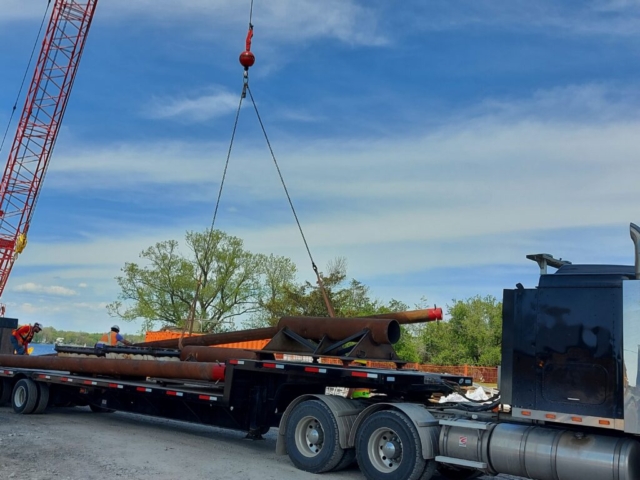 Spuds being delivered to site and offloaded with the 110 ton crane