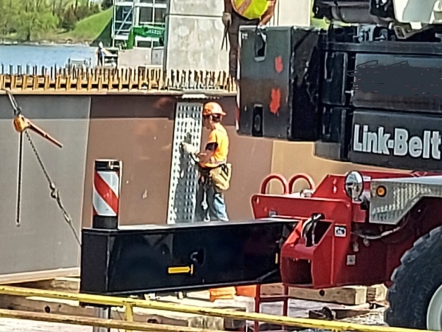 Installing the bolts in the splice plate connecting the two girder pieces