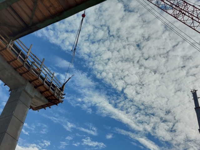 Lowering rebar with the 110 ton crane from pier cap 13