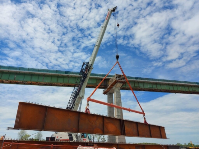 Second approach girder piece being offloaded from the truck