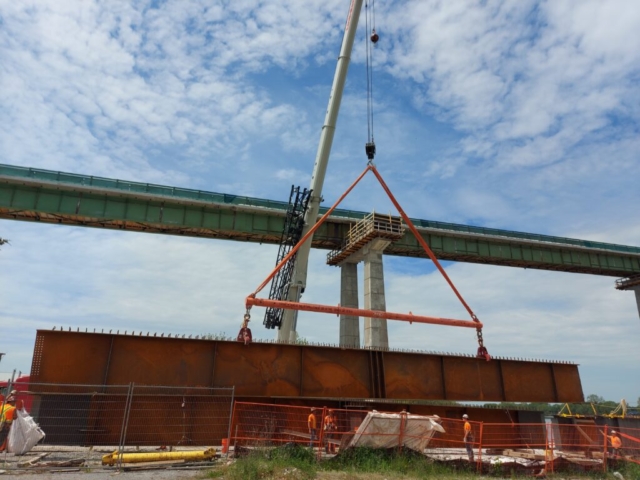 Second approach girder piece being lowered