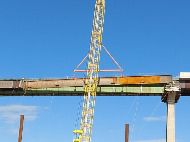 Lowering the approach girder into place