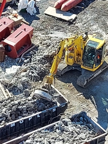 Top view of the excavator being used to sort the metal and concrete rubble