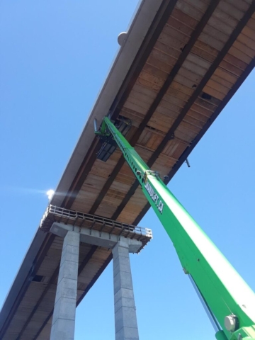 Using the manlift to access the false decking for formwork removal